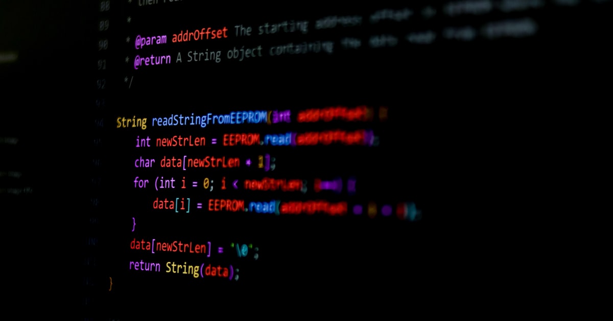 Lines of source code displayed on a black screen with syntax highlighting