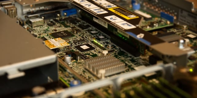Close-up of a high-end desktop motherboard showing CPU socket and large DDR5 RAM slots.