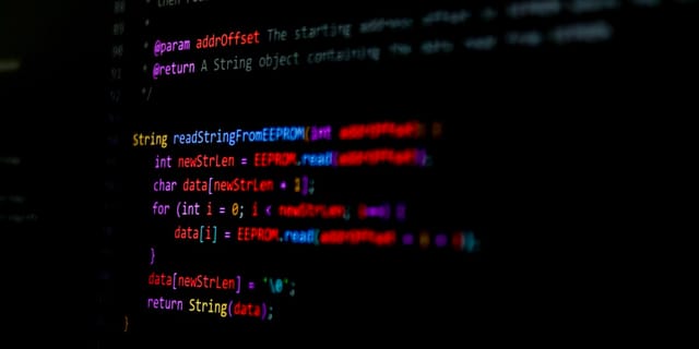 Lines of source code displayed on a black screen with syntax highlighting