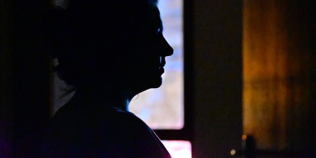 A person's silhouette standing in the dark — Ox Alpha's developer has chosen to remain anonymous