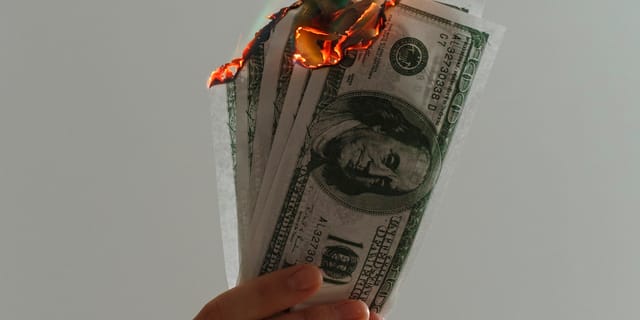 Time-lapse photograph of US dollar banknotes on fire