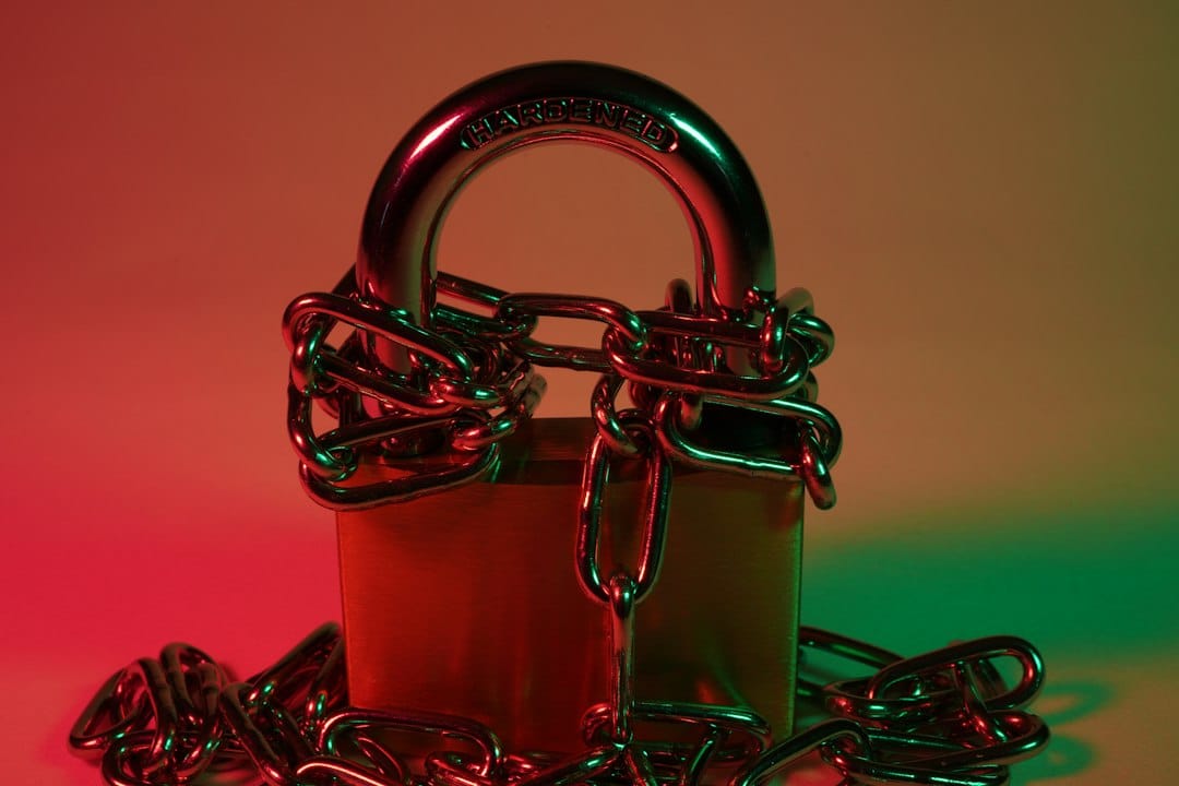 A red padlock locked onto a red metal chain, representing broken isolation between tenants.