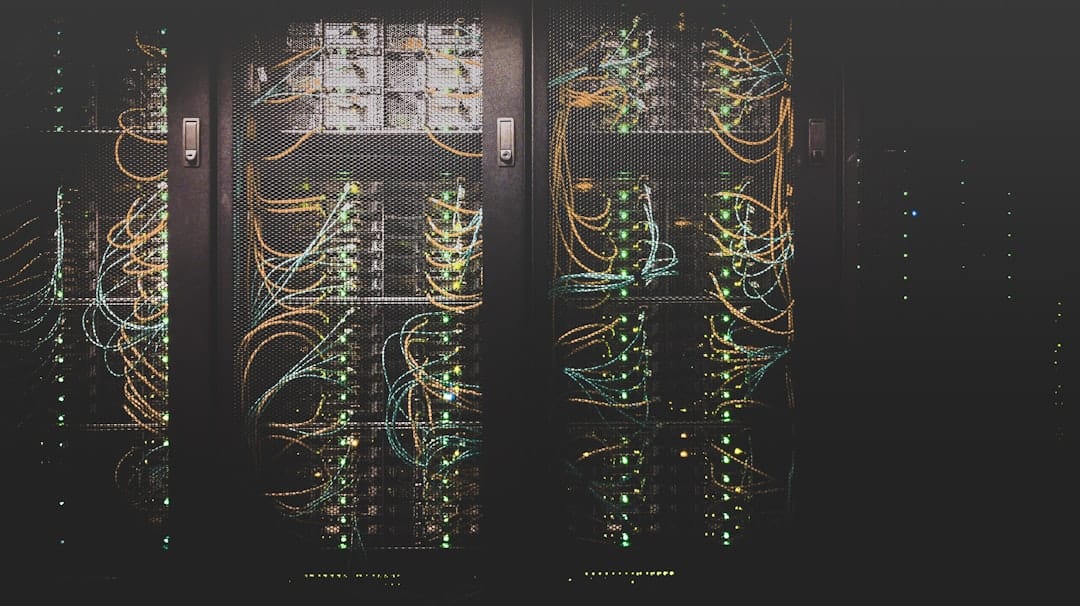Rows of server racks with cabling in a modern data center aisle.