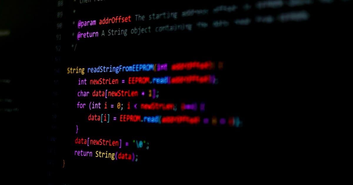 Lines of source code displayed on a black screen with syntax highlighting