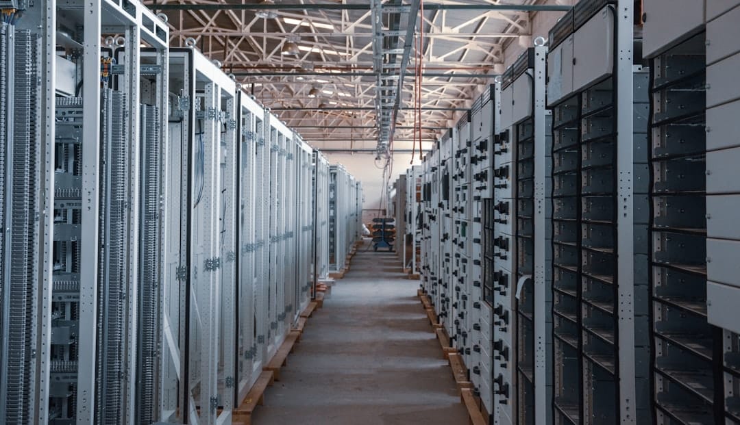 GPU server racks in a dim data center with cooling fans spinning