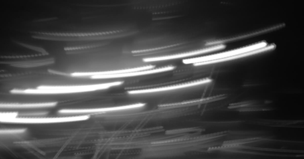 Motion blur of light streaks on a dark background suggesting high speed