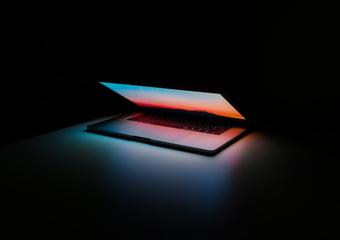 A dark terminal window filled with source code and shell commands on a laptop